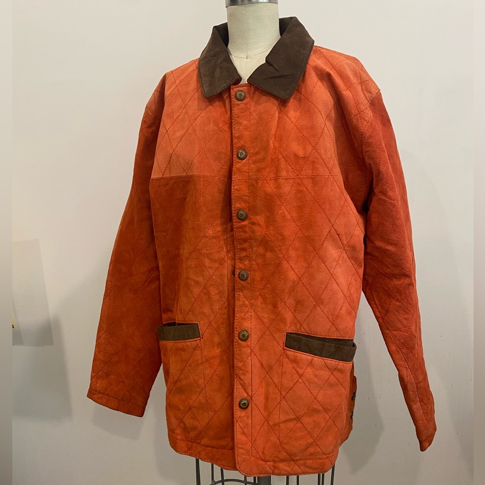 Vintage orange and brown leather jacket from the 1970’s. Loose fitting size L.